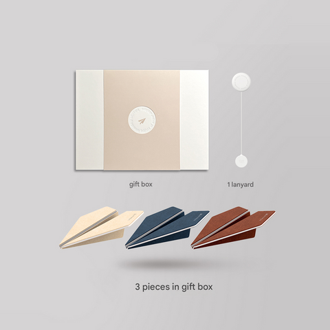 Gift box with lanyard and paper airplane-shaped items on a gray background