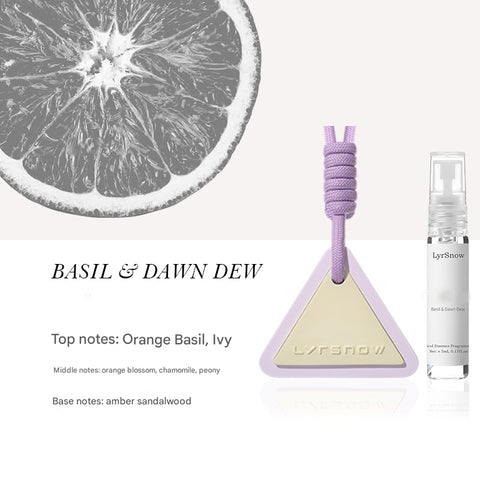 Perfume bottle with triangle design and lavender color, labeled 'LyrSnow', next to a slice of lemon.