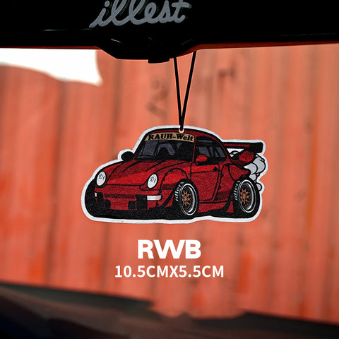 Red car air freshener with 'RAUH-Welt' branding on a blurred background