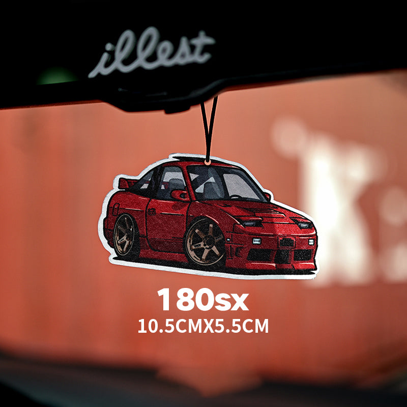 Red car-shaped air freshener hanging from a car's rearview mirror with 'illest' branding.
