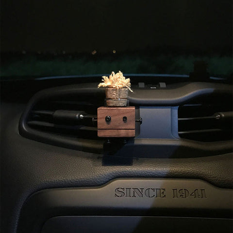 Decorative air freshener on a car dashboard with Fresure.