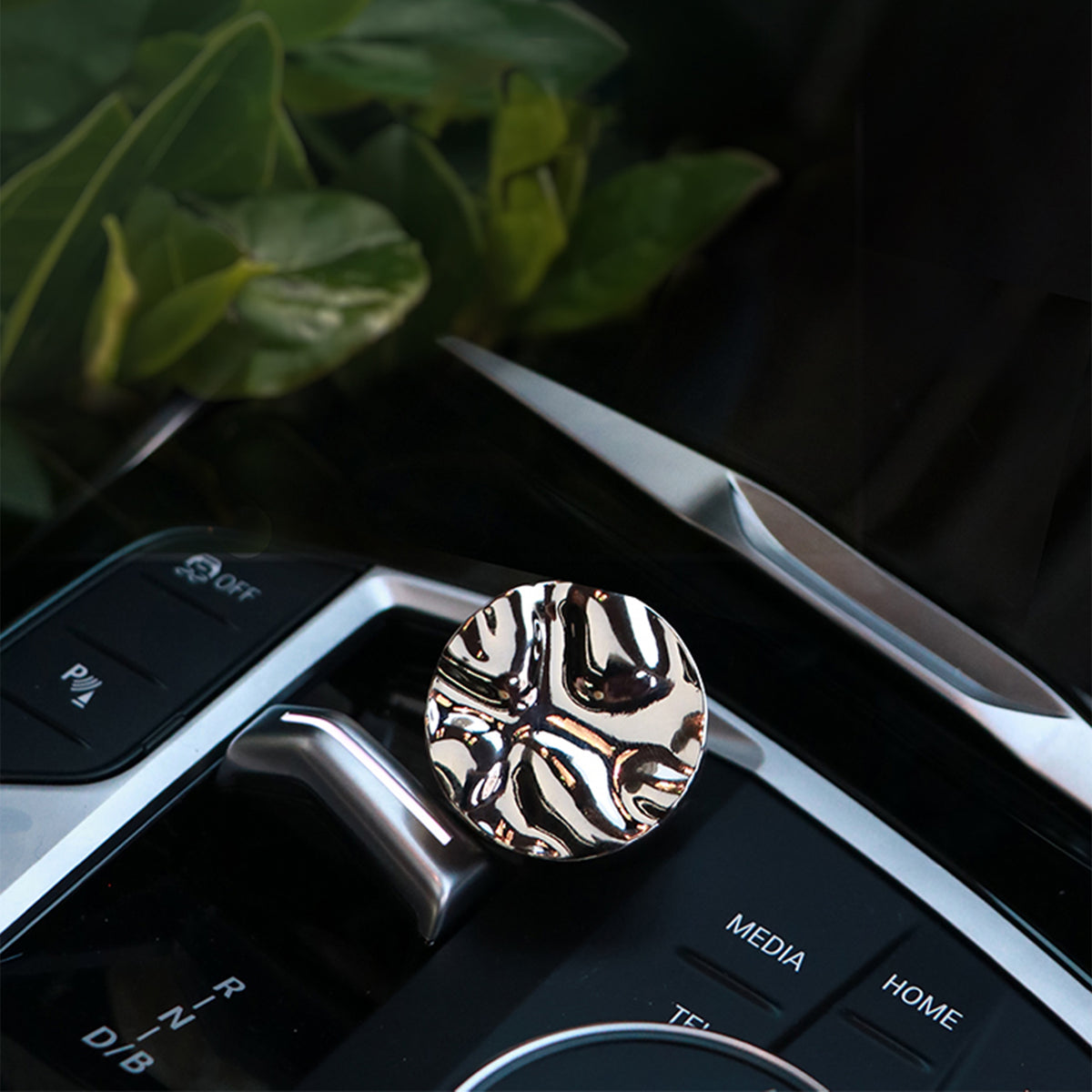 Metallic car air freshener with zebra pattern on a car dashboard