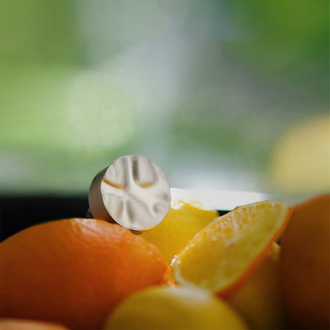 Close-up of sliced oranges with a blurred green background