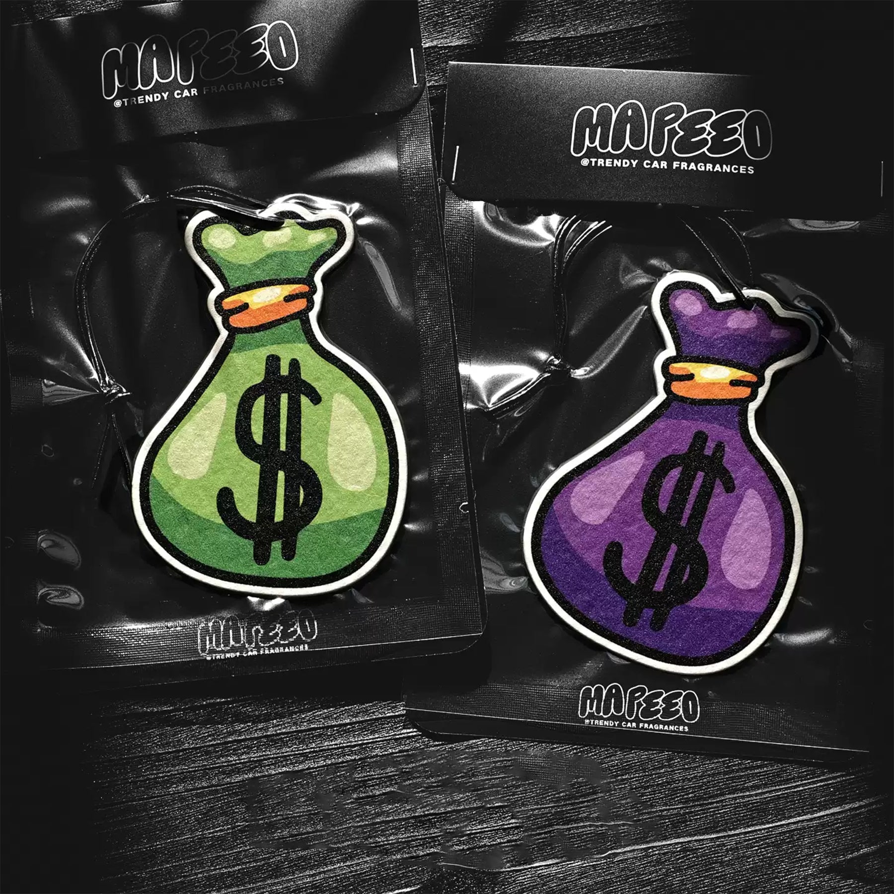 Two Mafeeo branded air fresheners in packaging on a dark surface