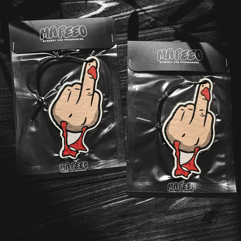 Two packages of Mafeeo car fragrances with a hand gesture design on a dark surface.