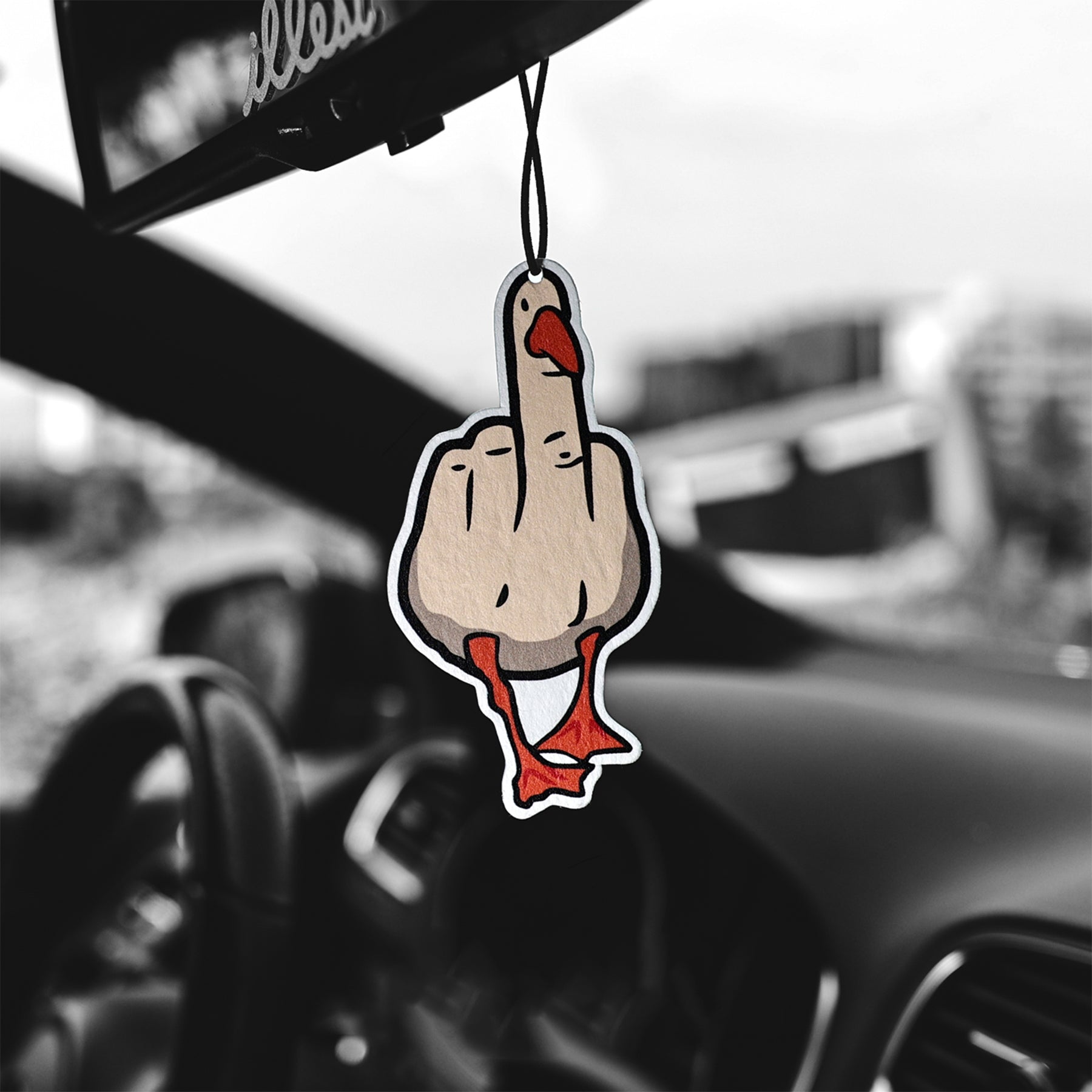 Car air freshener shaped like a hand giving the middle finger hanging from a car's rearview mirror.