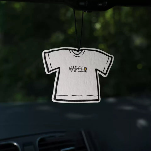 White t-shirt with 'MAPEE' logo hanging inside a car.