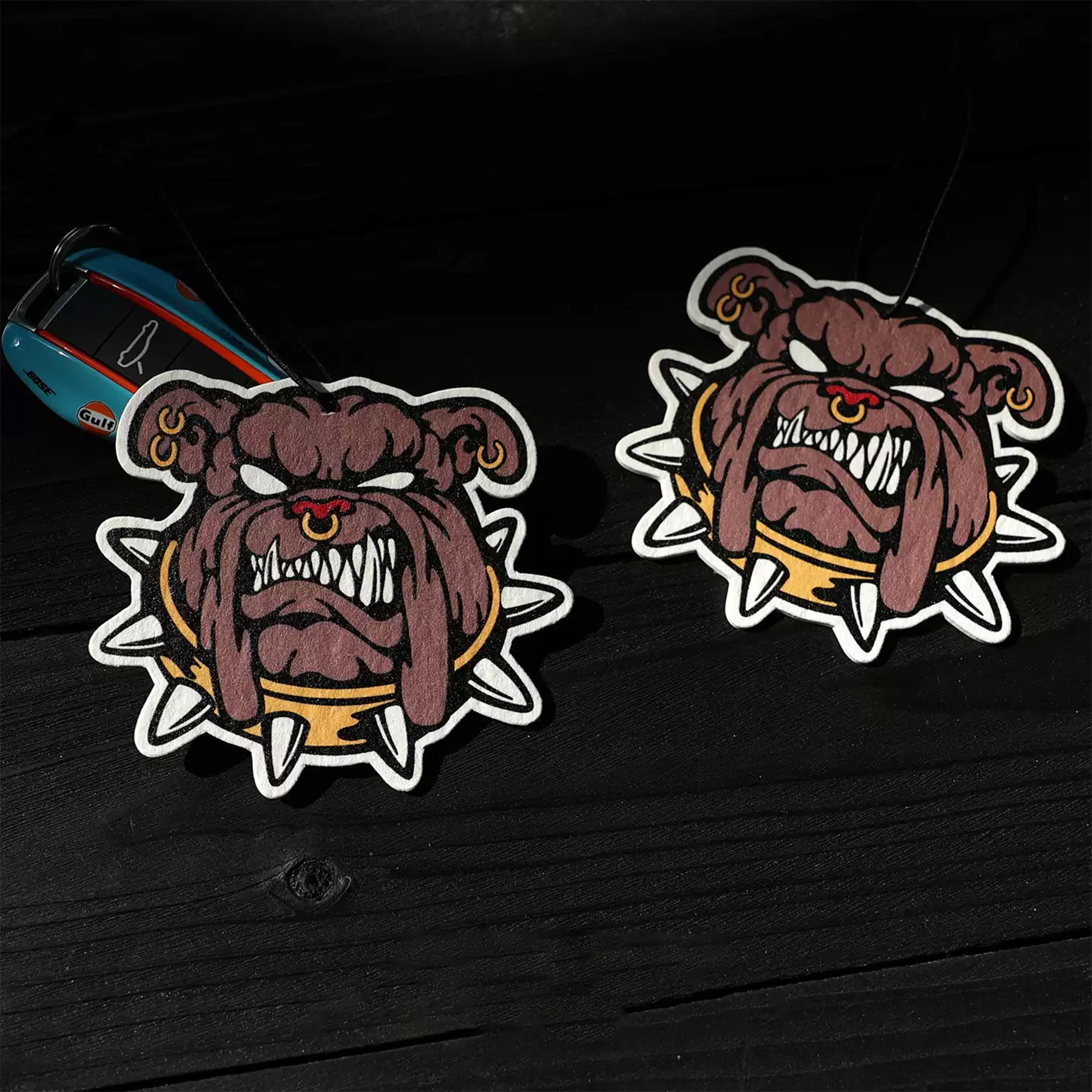 Two cartoon-style dog stickers on a dark surface