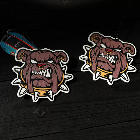 Two cartoon-style dog stickers on a dark surface