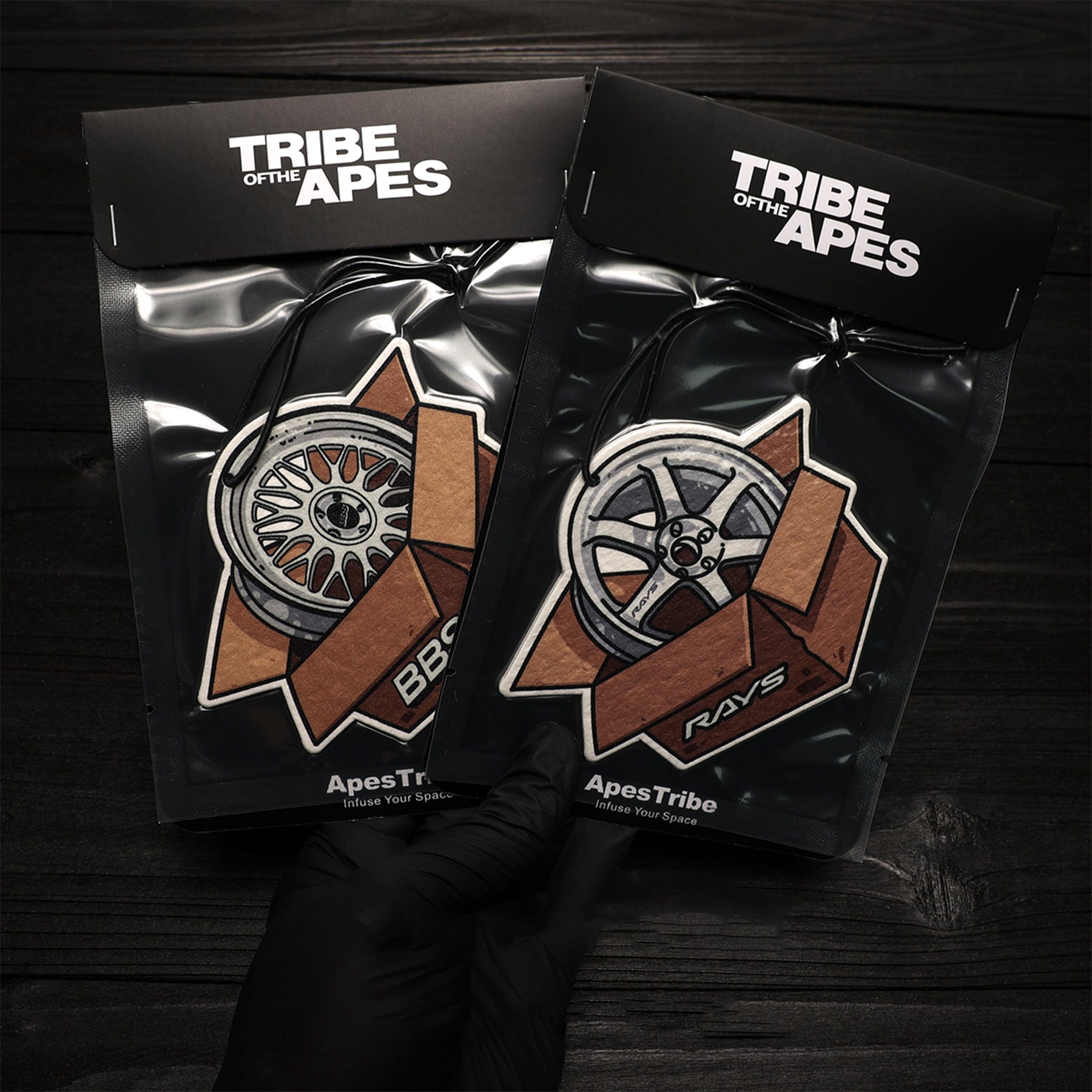 Two black packages with 'Tribe of the Apes' branding on a dark background