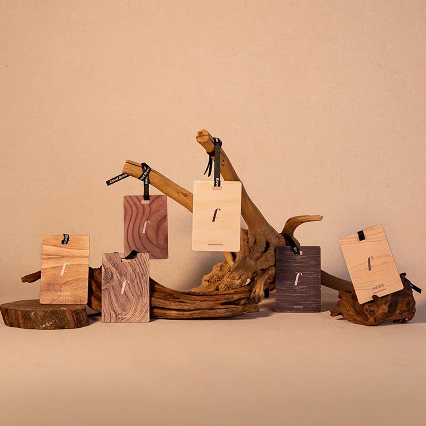 Wooden jewelry display with tags on a beige background