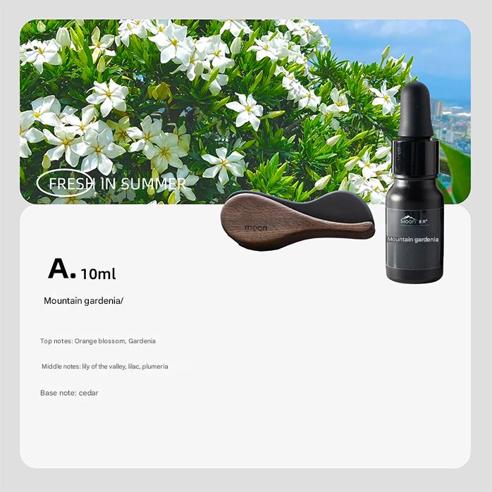 Black bottle with dropper labeled 'Mountain Gardenia' on a white background with greenery and flowers.