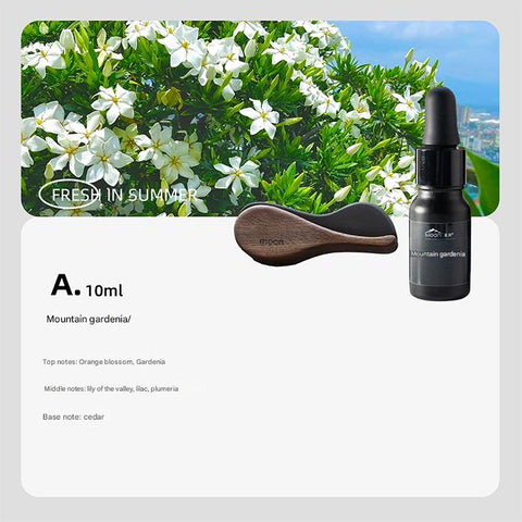 Black bottle with dropper labeled 'Mountain Gardenia' on a white background with greenery and flowers.