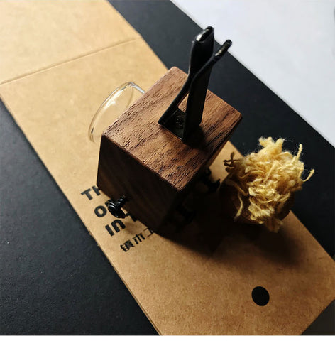 Wooden tool with black metal components on a textured surface